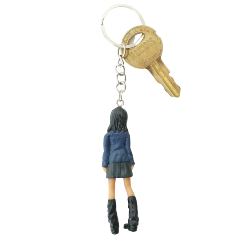 2000s Dolls Charm Prep Girl keychain back view in denim jacket