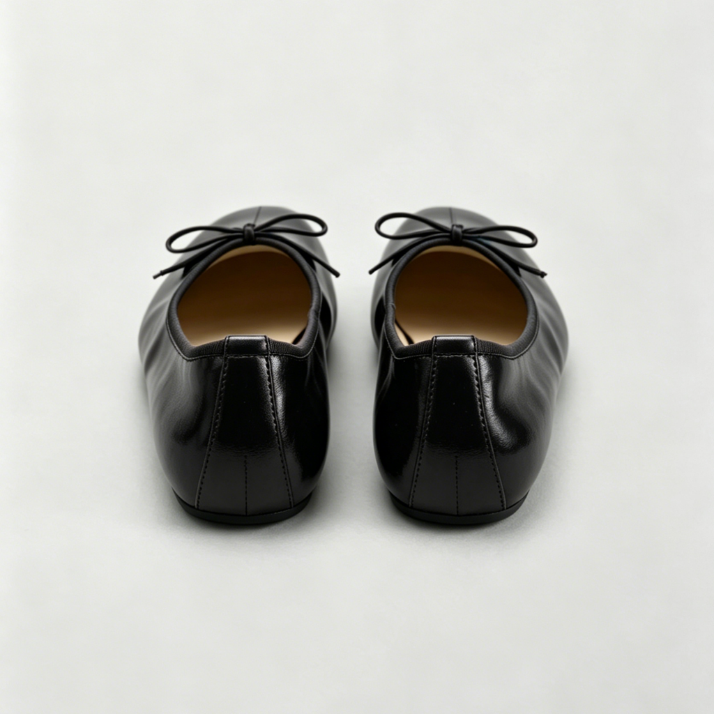 Pair of black leather shoes on a light gray background