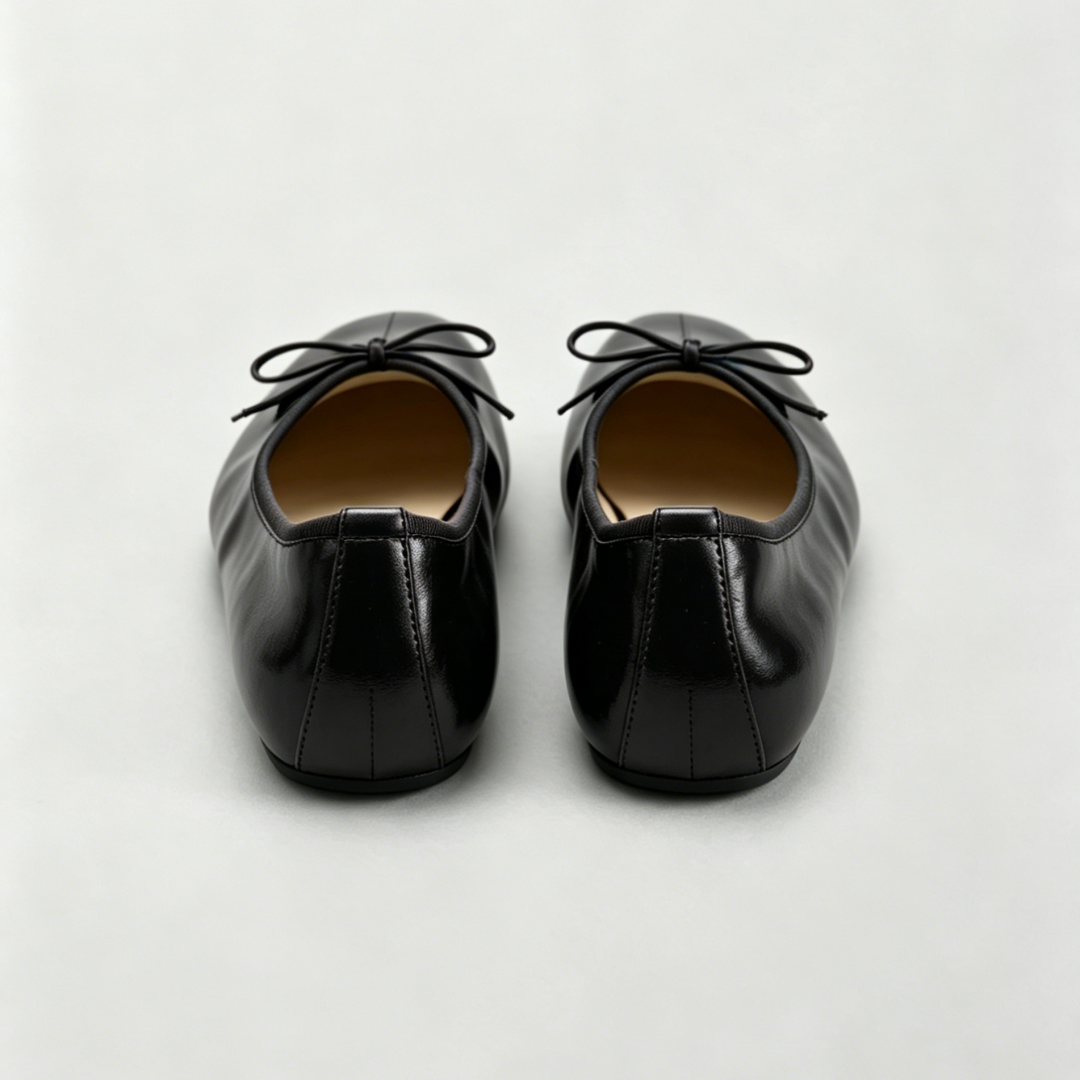 Pair of black leather shoes on a light gray background