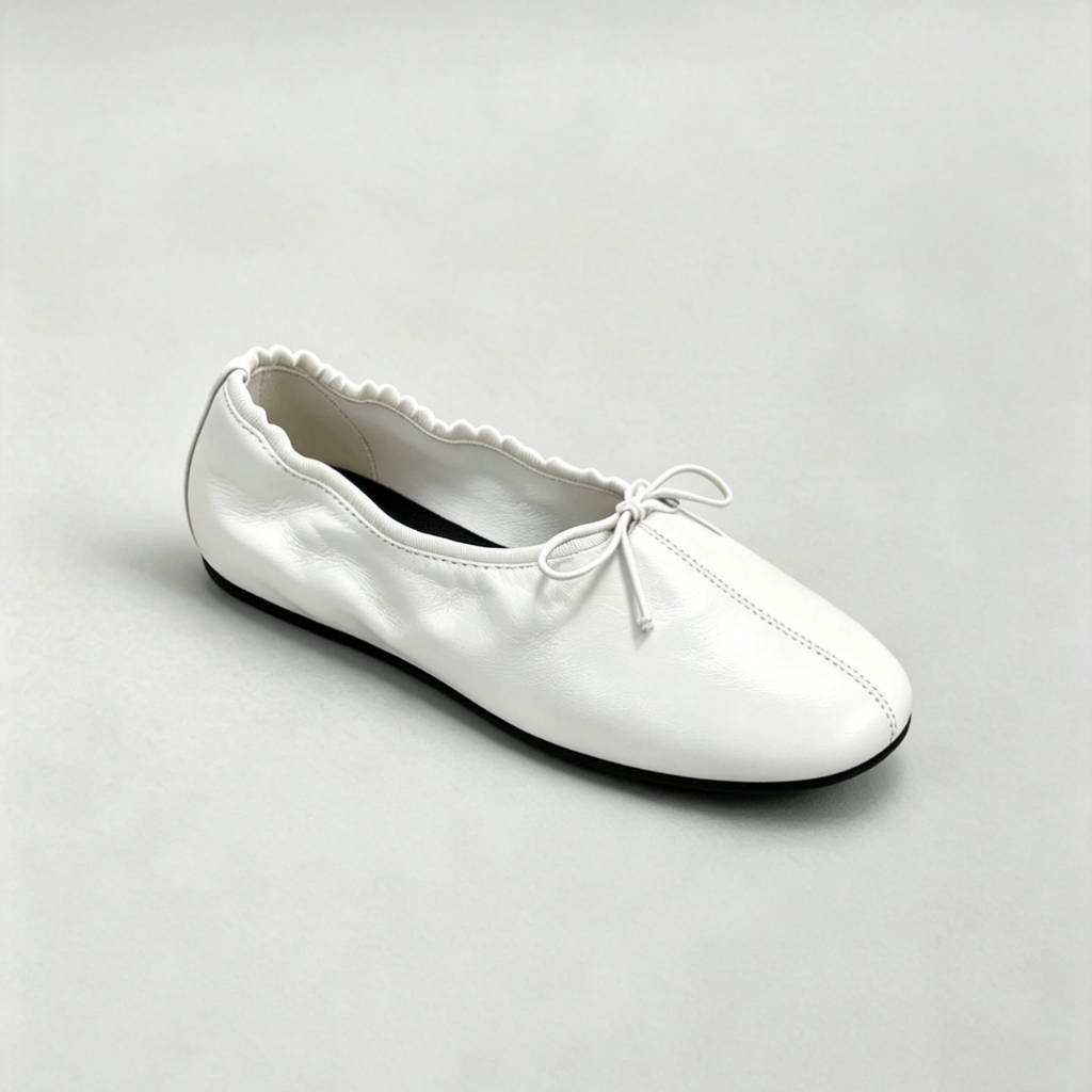 White ballet flat shoe on a light gray background
