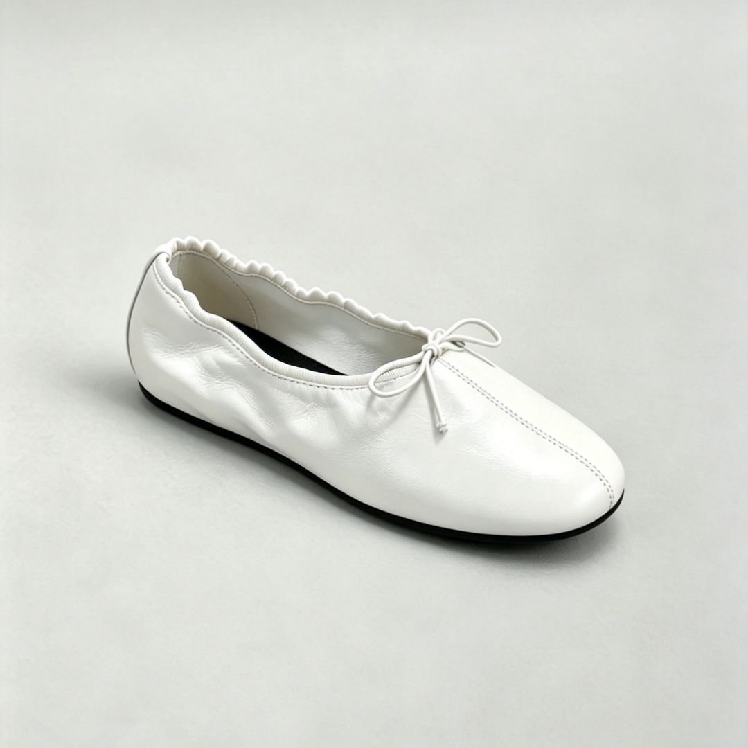 White ballet flat shoe on a light gray background