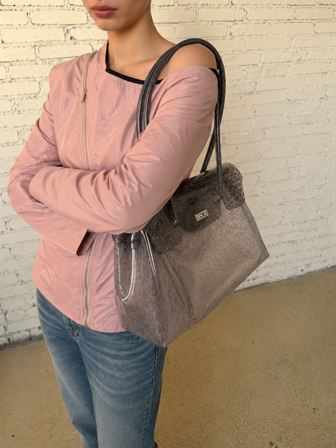 Jelly Firkin 40 Bag Croc Brown worn with pink jacket and blue jeans against white brick wall