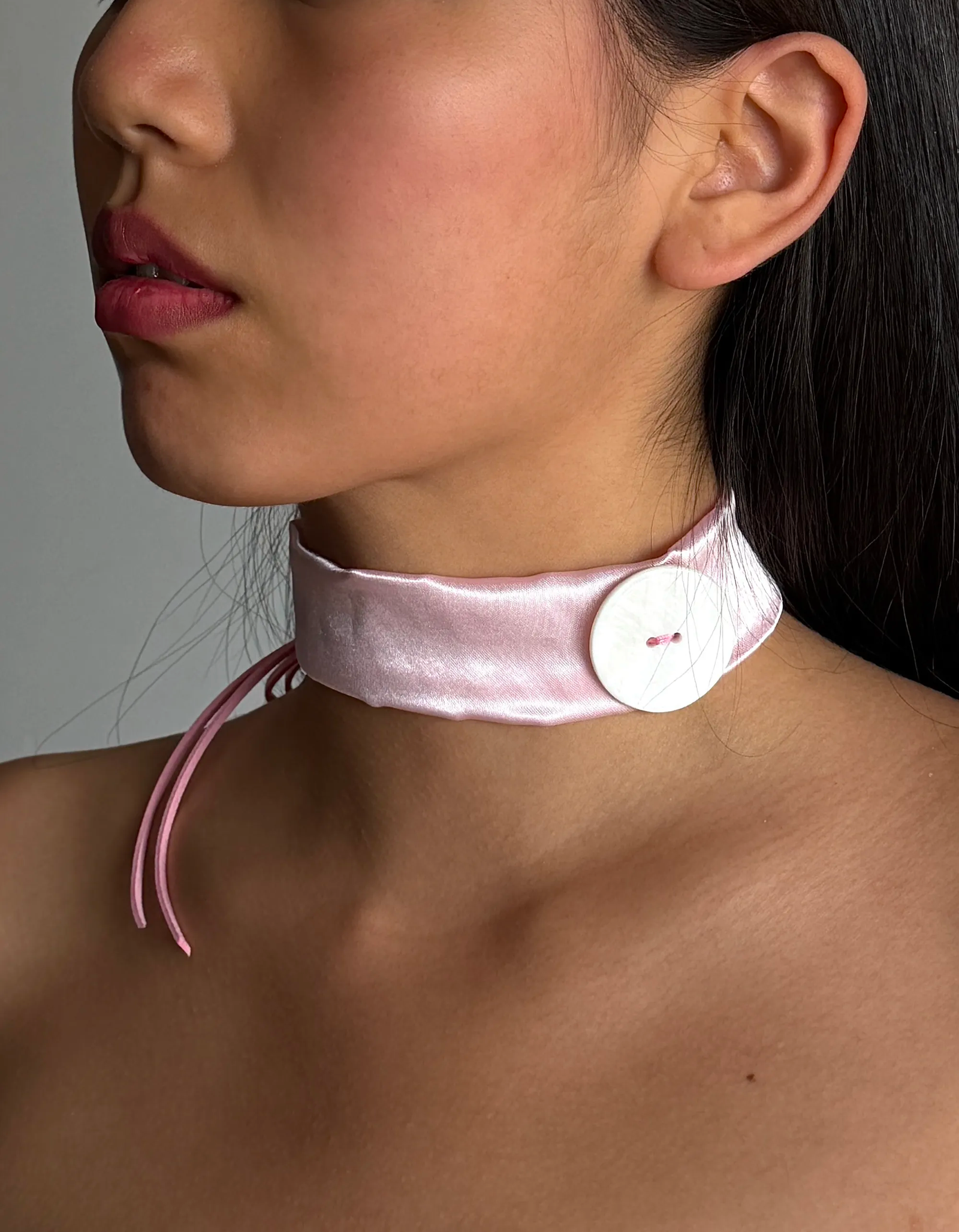 Lovepill Satin Button Choker Strawberry Milk worn on neck