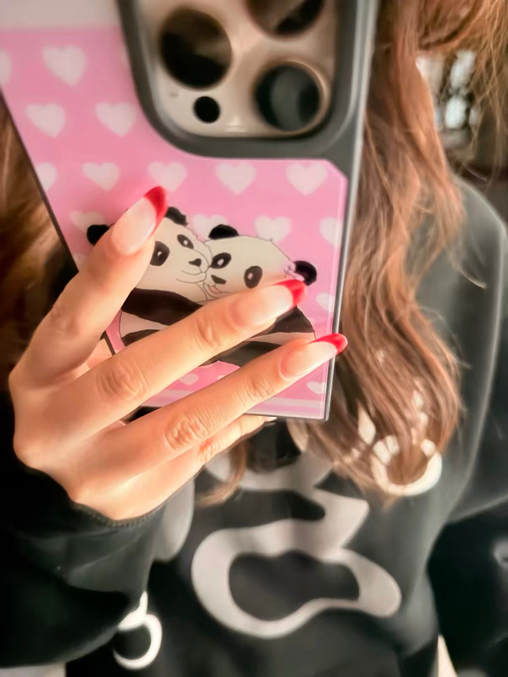 Panda Lovecore iPhone Case worn on phone held by model