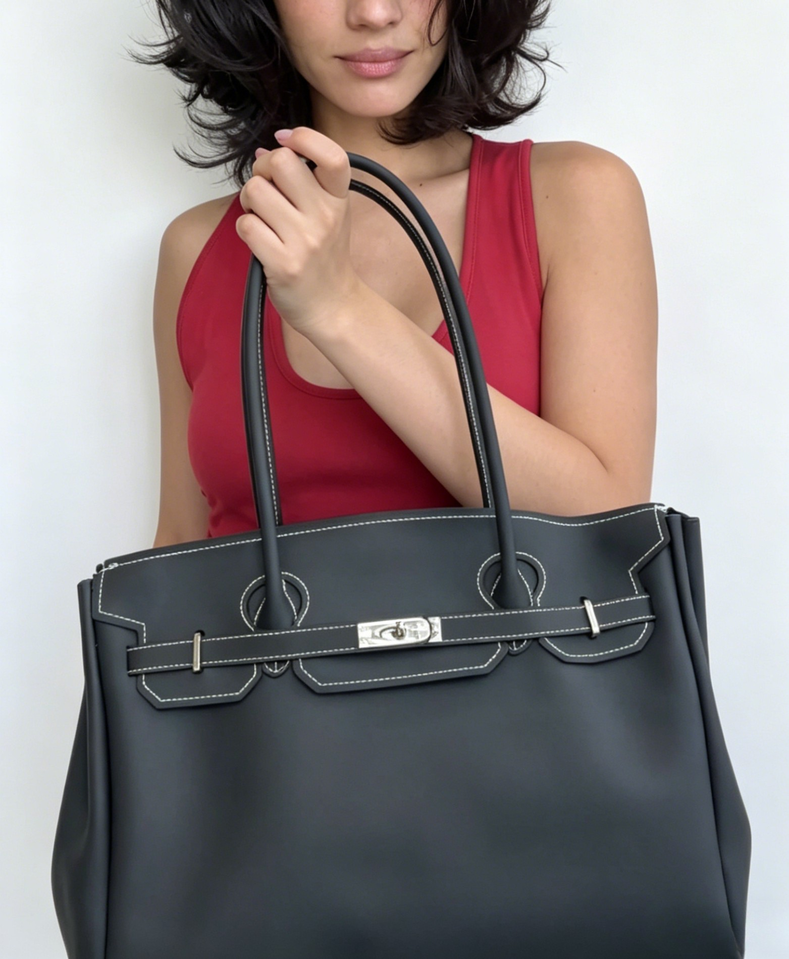 Jelly Firkin 40 Bag Classic Black held by woman against white background
