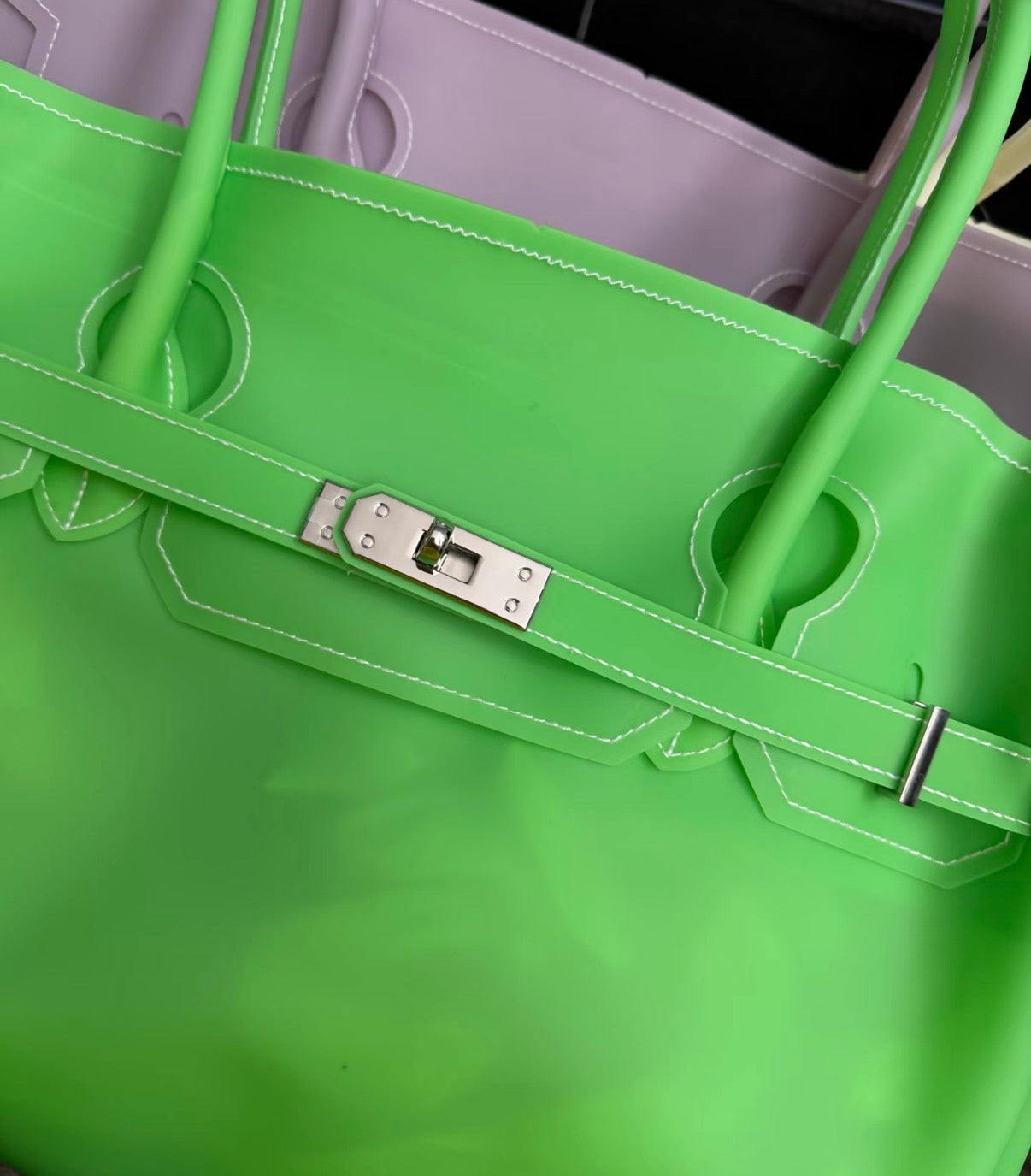 Jelly Firkin 40 Bag Classic Neon Green with silver hardware on blurred background