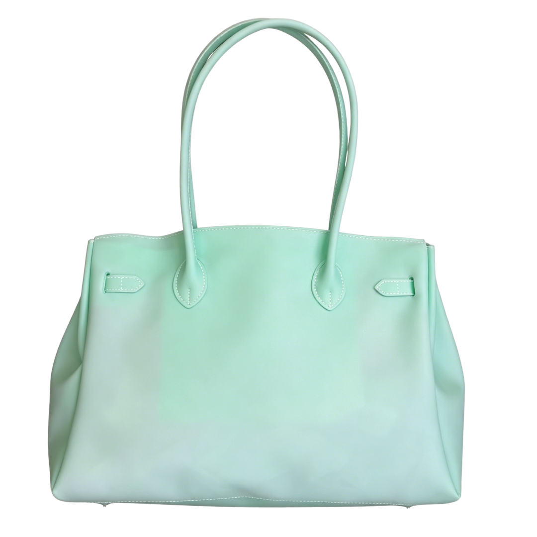 Mint green handbag on a white background