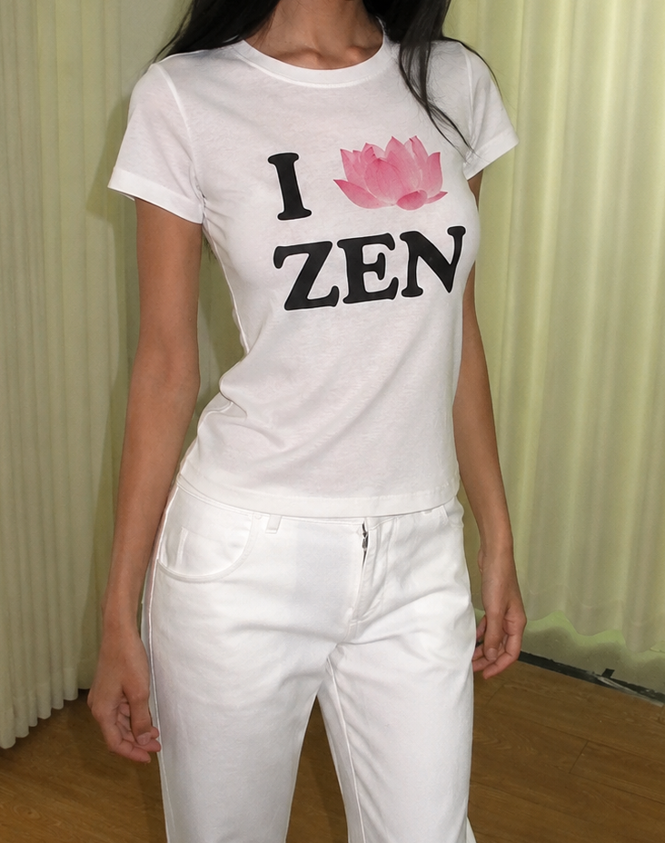 Person wearing a white t-shirt with 'I ❤️ ZEN' text and pink lotus flower design.